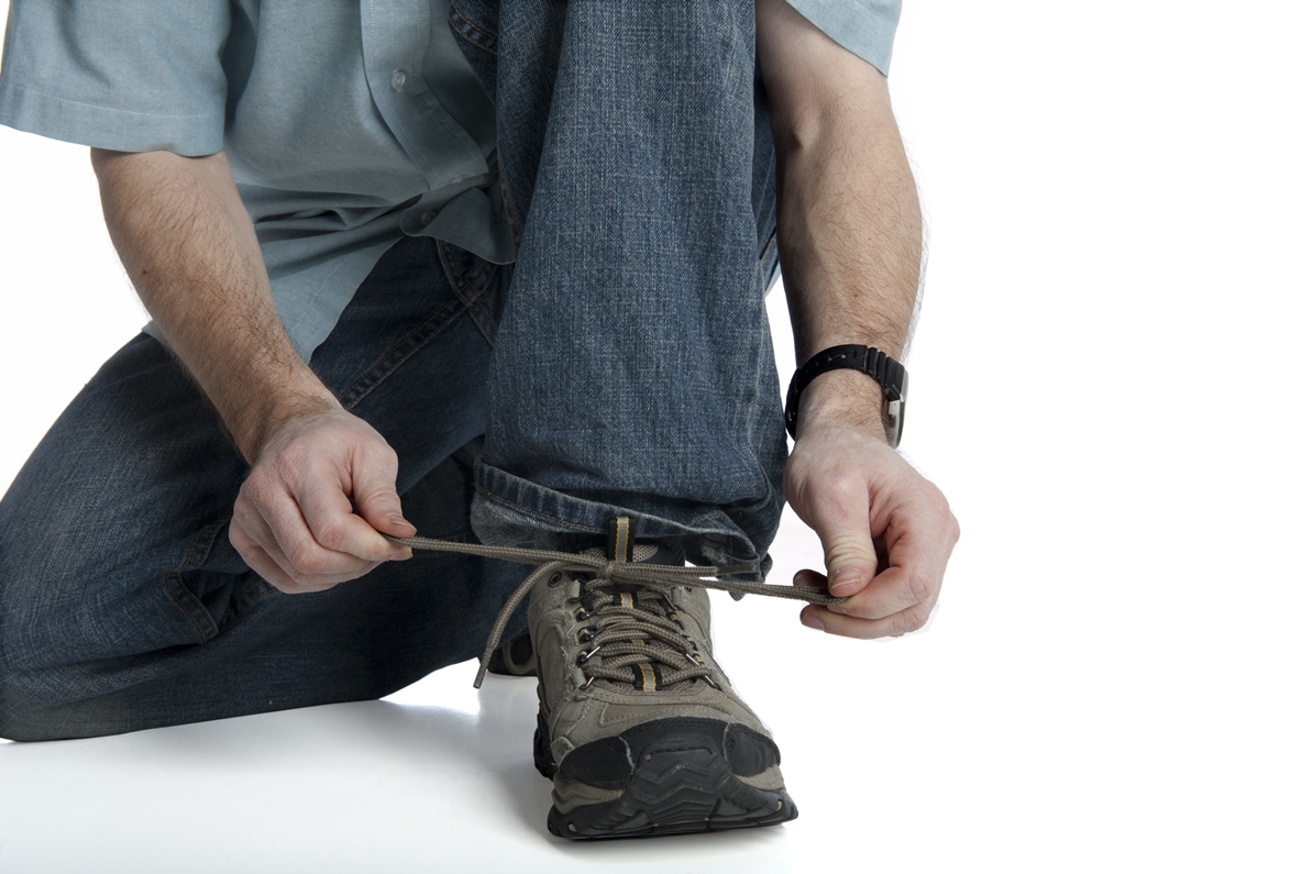 Een man die veter strikt