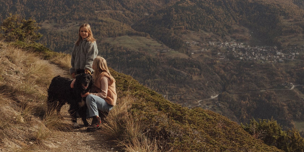 vrouw, meisje en hond in de bergen.