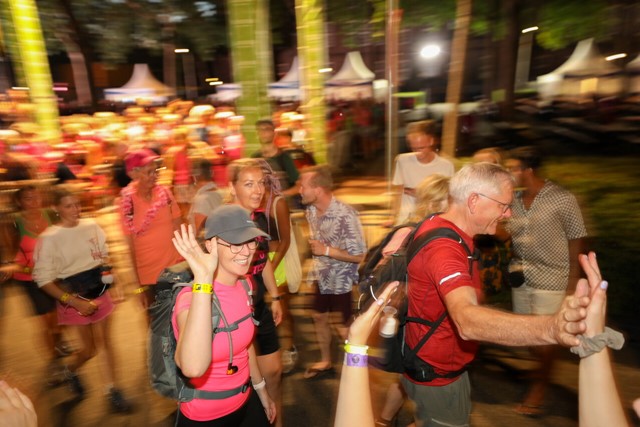 4Daagselopers in de vroege ochtend doen een high-five.
