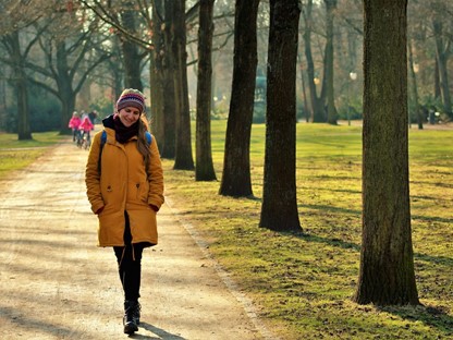 afbeelding van een vrouw die in het park wandelt.