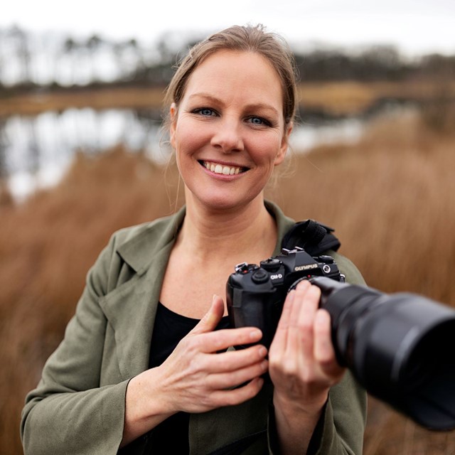 afbeelding van fotograaf Linda Verweij met een camera in haar hand.