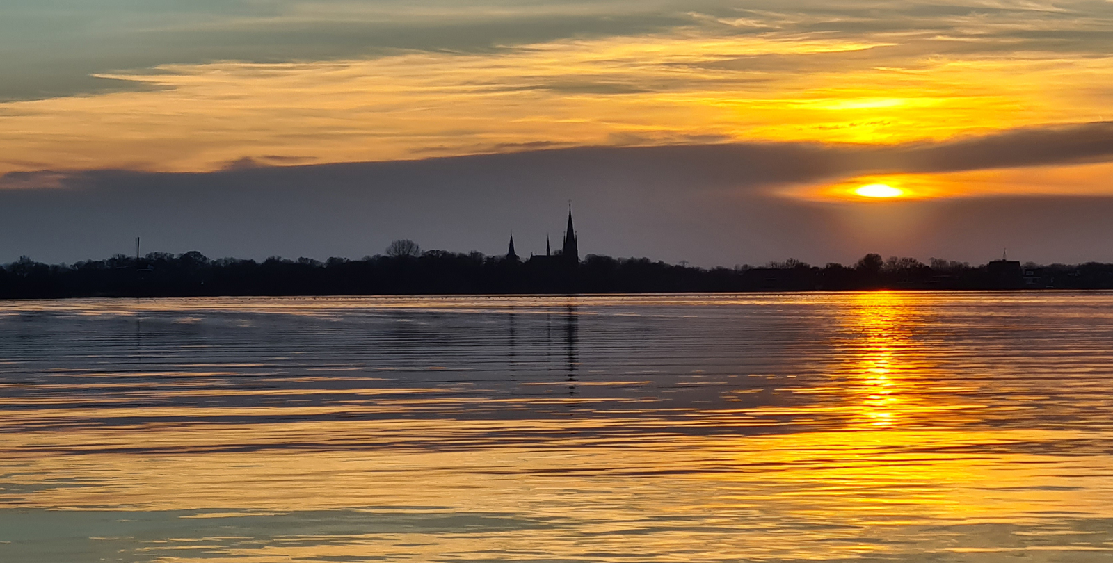 afbeelding van een goudgelen zonsondergang aan de Spiegelplas.