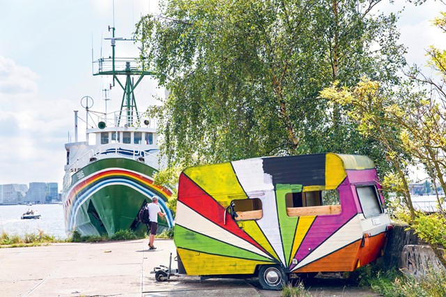 afbeelding van een kleurrijke caravan en schip in Amsterdam-Noord.