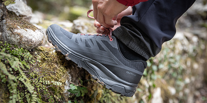 Veter strikken van wandelschoen op muurtje